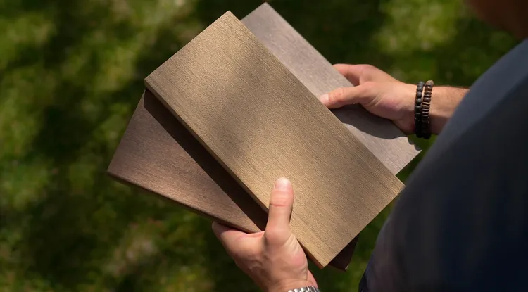 Person holding TimberTech decking samples