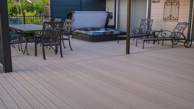 A sunken hot tub set into an AZEK Landmark Collection deck in French White Oak under a 4K aluminum slatted pergola, with a view across Lake of the Pines, photographed at golden hour on a lakefront home in Auburn, California. Built by Stone Ridge Decking — custom decks across Northern California, serving Granite Bay, Folsom, Roseville, Lake Tahoe, Auburn, Sacramento, and Grass Valley. https://stoneridgedecking.com