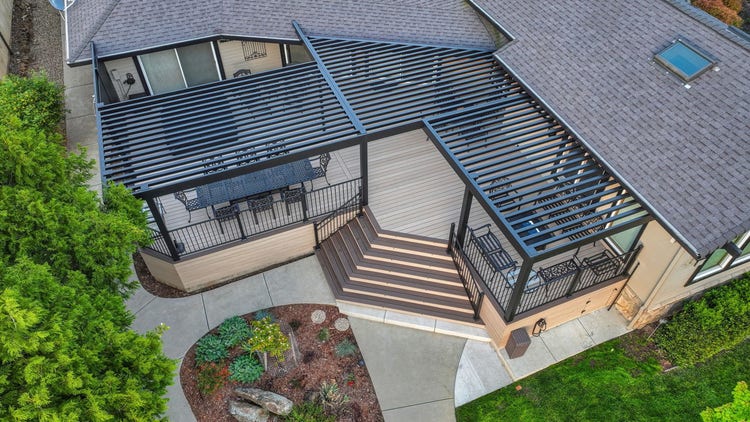 Aerial / drone view of an AZEK Landmark Collection deck in French White Oak with American Walnut picture-frame border, a 4K aluminum slatted pergola in matte black, TimberTech Fulton Rail Steel, a sunken hot tub, and a private dock — on a lakefront lot on Lake of the Pines in Auburn, California, photographed from directly overhead. Built by Stone Ridge Decking — custom decks across Northern California, serving Granite Bay, Folsom, Roseville, Lake Tahoe, Auburn, Sacramento, and Grass Valley. https://stoneridgedecking.com