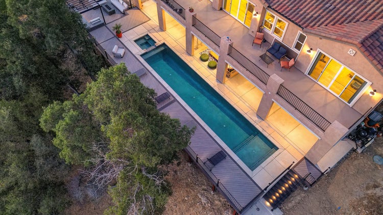 Deck featuring pool spa, Fortress powder-coated steel louvered pergola, Blaze outdoor kitchen with Dark Hickory cladding, and linear gas fire pit. Built by Stone Ridge Decking, a custom deck builder serving El Dorado Hills, Folsom, Lake Tahoe, Auburn, Sacramento, Grass Valley, Cameron Park, and surrounding Northern California communities. https://stoneridgedecking.com