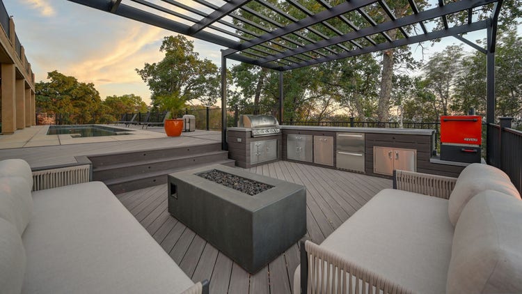 Deck featuring multi level, Fortress powder-coated steel louvered pergola, Blaze outdoor kitchen with Dark Hickory cladding, and linear gas fire pit. Built by Stone Ridge Decking, a custom deck builder serving El Dorado Hills, Folsom, Lake Tahoe, Auburn, Sacramento, Grass Valley, Cameron Park, and surrounding Northern California communities. https://stoneridgedecking.com