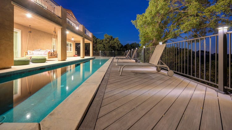 Deck featuring pool deck, Fortress powder-coated steel louvered pergola, Blaze outdoor kitchen with Dark Hickory cladding, and linear gas fire pit. Built by Stone Ridge Decking, a custom deck builder serving El Dorado Hills, Folsom, Lake Tahoe, Auburn, Sacramento, Grass Valley, Cameron Park, and surrounding Northern California communities. https://stoneridgedecking.com