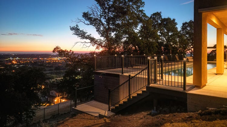 Deck featuring deck stairs, Fortress powder-coated steel louvered pergola, Blaze outdoor kitchen with Dark Hickory cladding, and linear gas fire pit. Built by Stone Ridge Decking, a custom deck builder serving El Dorado Hills, Folsom, Lake Tahoe, Auburn, Sacramento, Grass Valley, Cameron Park, and surrounding Northern California communities. https://stoneridgedecking.com