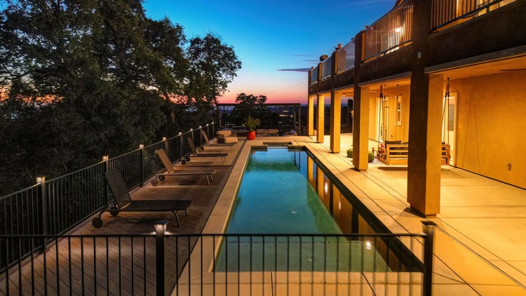 Deck featuring pool deck, Fortress powder-coated steel louvered pergola, Blaze outdoor kitchen with Dark Hickory cladding, and linear gas fire pit. Built by Stone Ridge Decking, a custom deck builder serving El Dorado Hills, Folsom, Lake Tahoe, Auburn, Sacramento, Grass Valley, Cameron Park, and surrounding Northern California communities. https://stoneridgedecking.com