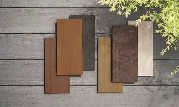 Two piles of TimberTech deck boards, three boards each, nicely stacked to show color variation and texture. The boards range from dark browns to light tans to the lightest beige colors.