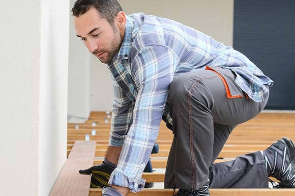 Contractor putting down deck flooring