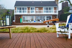 Deck featuring TimberTech AZEK Vintage Collection Mohagany with white adirondack chair