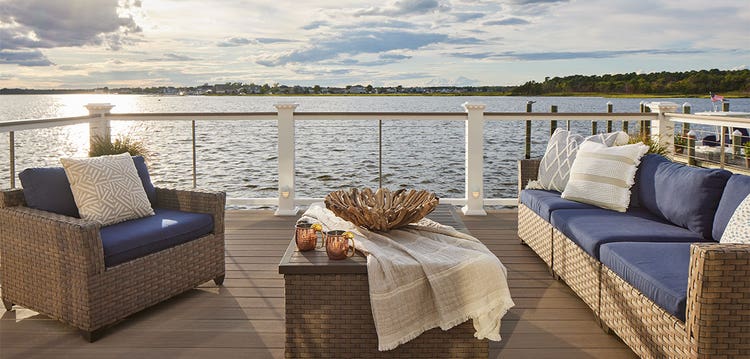 Navy blue outdoor seating on a deck overlooking the ocean.