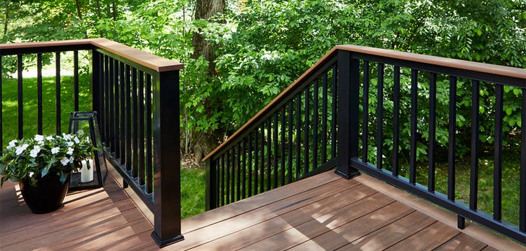 Wood deck with a black drink rail allows guests to set their drinks down.