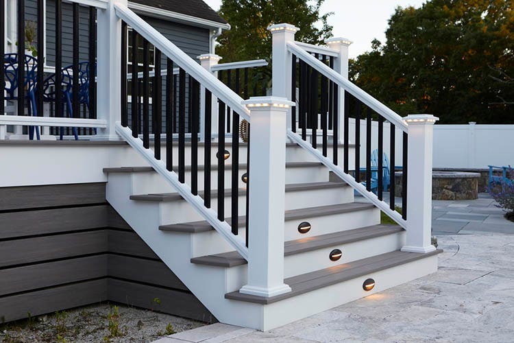 Deck lights in the stairs and railing of a gray composite deck increase ambience and visibility