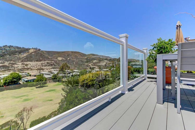 Railing with glass balusters overlooking rural city