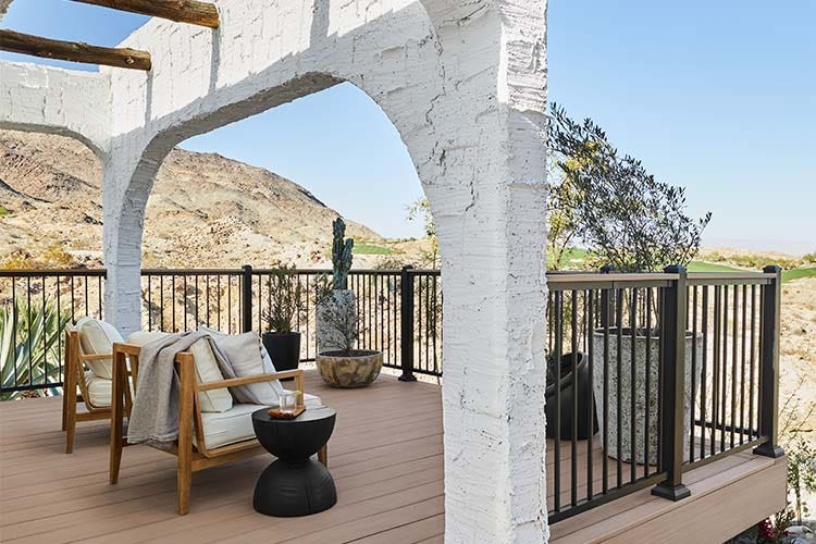 A white stucco arch extends over the composite deck at the Bobby Berk home, Casa Tierra