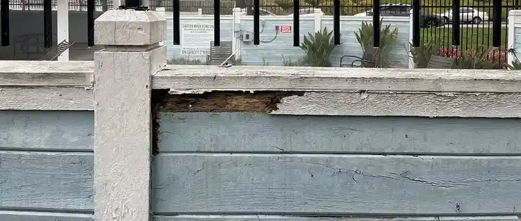 A rotting wooden railing