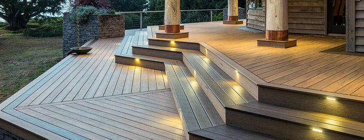 Angled composite deck stairs in a sprawling backyard