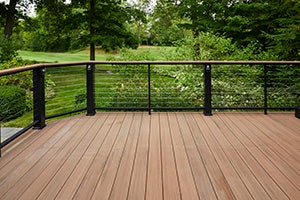 Backyard view of a design-your-own deck featuring TimberTech AZEK Vintage Collection in English Walnut
