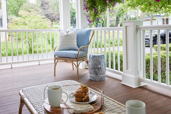 Front porch deck ideas include a traditional railing like white composite Premier Rail