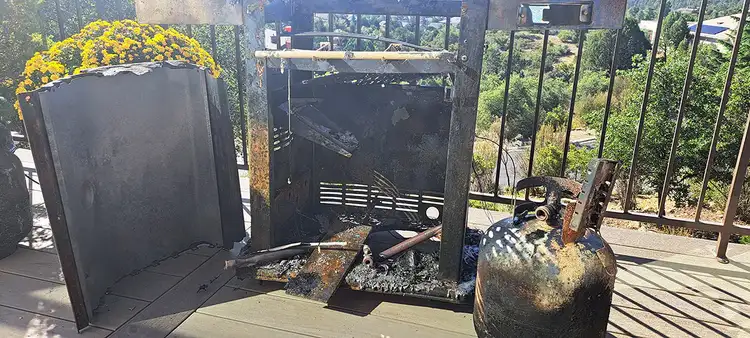 The remains of a grill that caught on fire on a TimberTech deck