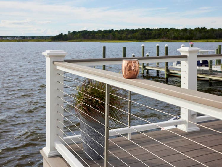Lakeside deck ideas with bronze cup on railing on dock