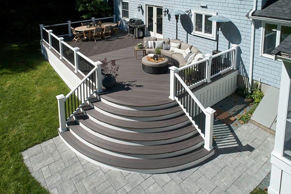Deck ideas with curved stairs on a furnished backyard deck