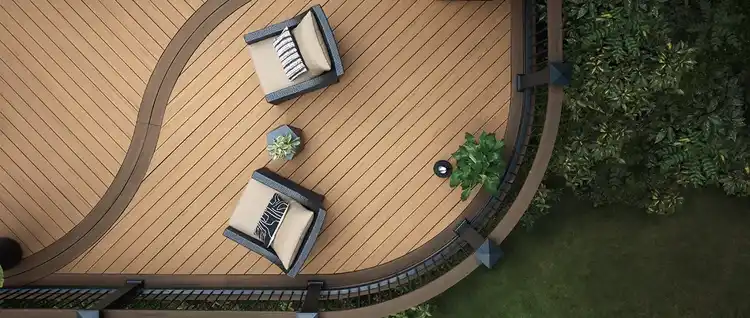 An overhead image of a TimberTech Composite Deck using deck boards from both the Reserve Collection in the color Antique Leather and the Vintage Collection in English Walnut. The deck features curved design with complimentary railing.