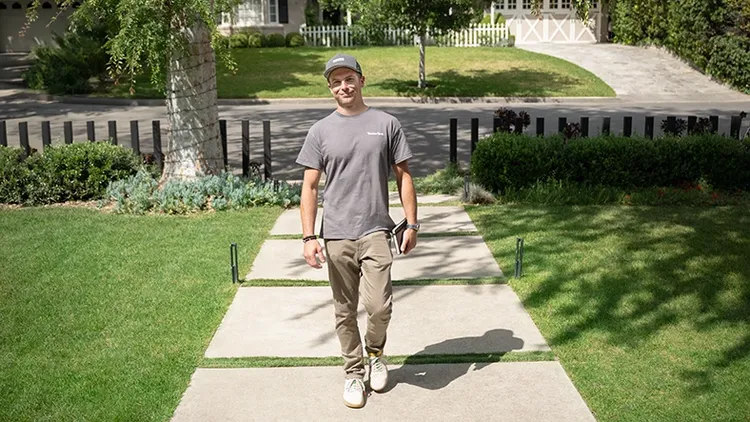 TimberTech contractor walks up to home with notebook