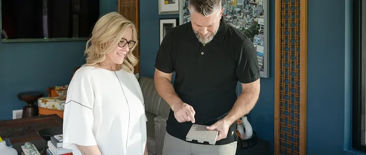 TimberTech contractor reviews a decking sample with a homeowner