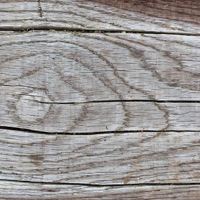 Deck damage can be seen in a wood deck's ledger board