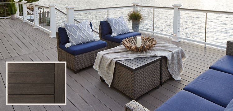 Modern PVC decking overlooking a lake with light-colored outdoor furniture