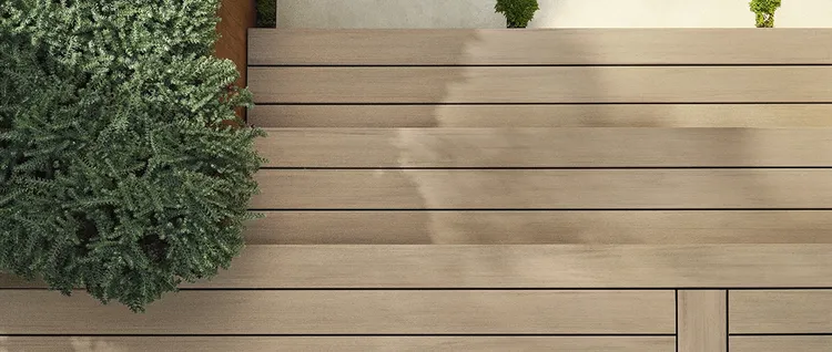 Overhead shot of stairs leading up to a light tan deck.