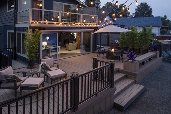 Temporary lighting string lights hung over TimberTech capped polymer deck