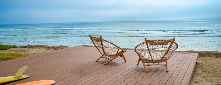 Standing water on composite deck boards insight featuring TimberTech AZEK Vintage Collection Mahogany deck