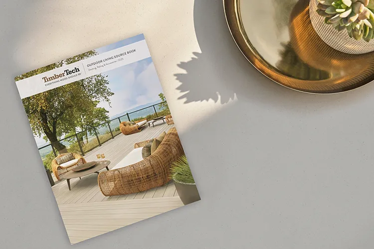 The Outdoor Living Source Book catalog is pictured on a countertop next to a potted plant