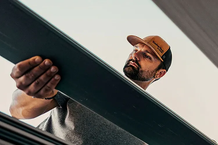 A TimberTech-trained contractor places a deck board on a job site