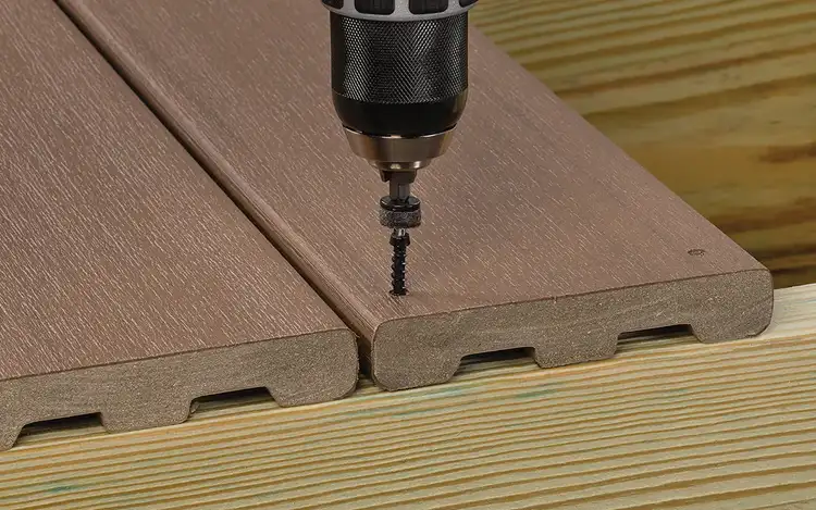 Hidden fastener is drilled into a deck board