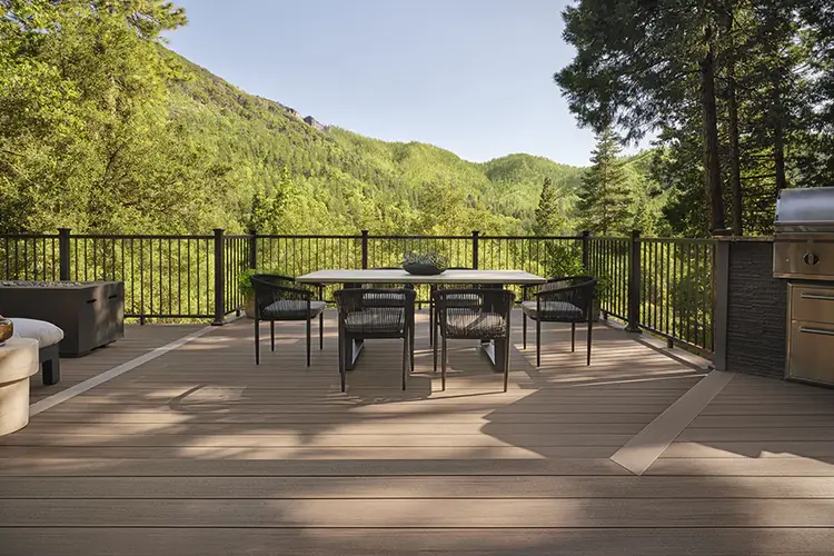 An outdoor dining room table and chairs on Tiffani's deck