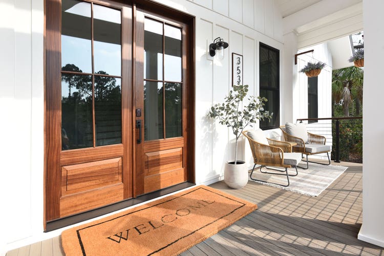 A welcoming front porch with a large wooden door, a
