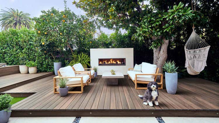 A patio with pecan decking and a outdoor fireplace decorated with white stucco. This image appeared in Sunset Magazine. Read more details by clicking 'View Story' below.