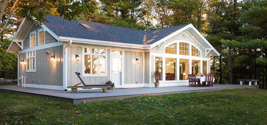 Outdoor living space plans for a farmhouse-style home featuring TimberTech PRO Terrain Collection in Silver Maple