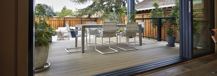 Backyard porch built rom TimberTech Porch in Weathered Teak, with industrial-chic contemporary seating