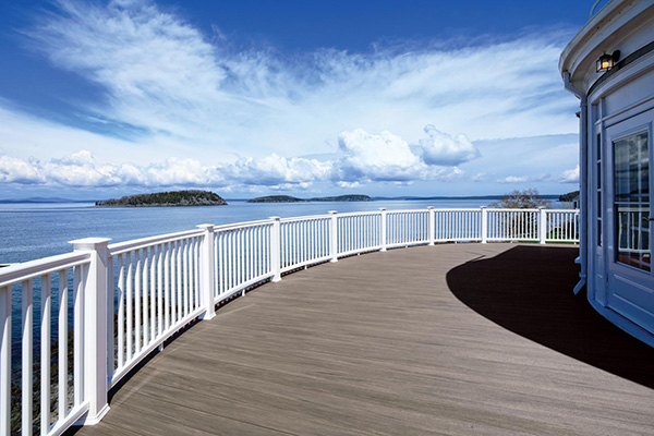 Gray composite decking TimberTech AZEK Vintage Collection Coastline curved deck with water view