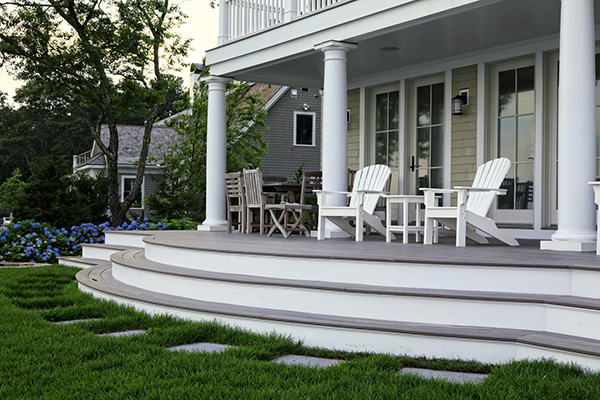 Gray composite decking with white pillars and stair risers