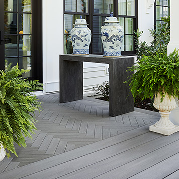 Herringbone deck pattern on porch featuring ornate vases