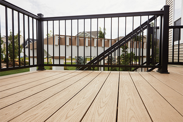 Detail view of Impresion Rail and TimberTech AZEK Harvest Collection decking in Brownstone