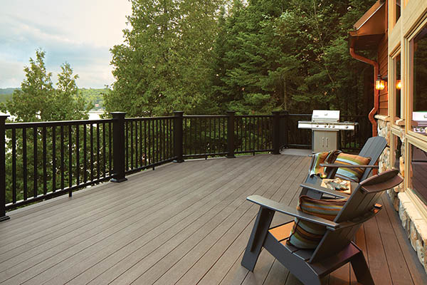 Deck featuring TimberTech AZEK Vintage Collection in Dark Hickory with green Adirondack chairs