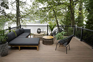 Deck featuring TimberTech AZEK Vintage Collection in English Walnut with black outdoor furniture