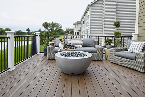 Black composite decking TimberTech PRO Reserve Collection in Dark Roast with dog laying on furniture