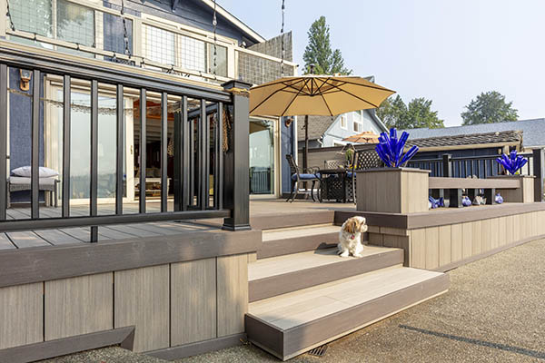 Creative Deck Ideas featuring TimberTech AZEK Vintage Collection in Coastline and Dark Hickory with dog sitting on stairs