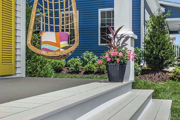 Recycle decking material featuring TimberTech AZEK Harvest Collection in Slate Gray with hanging chair