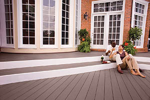 Deck featuring TimberTech AZEK Harvest Collection in Kona with couple sitting on steps