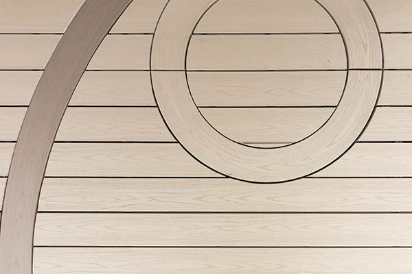 curved composite decking TimberTech AZEK Harvest Collection in Brownstone with small circle inlay